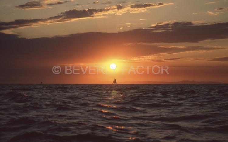 Sunset;colorful;sky;dana point ca;clouds;blue water;sun;yellow;water;boat;red;sillouettes;sailboats;ocean